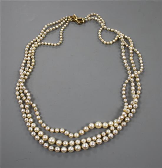 A triple strand graduated cultured pearl necklace, with 925 gilt clasp (a.f.). approx. 52cm.